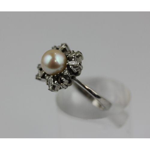 517 - A diamond and cultured pearl cluster ring, mounted with marquise and circular cut diamonds surroundi... 