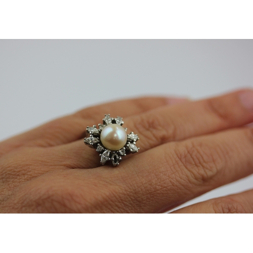 517 - A diamond and cultured pearl cluster ring, mounted with marquise and circular cut diamonds surroundi... 