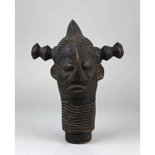 784 - An African tribal carved wooden head, featuring twin handles and inset with metal nails, the wear an... 