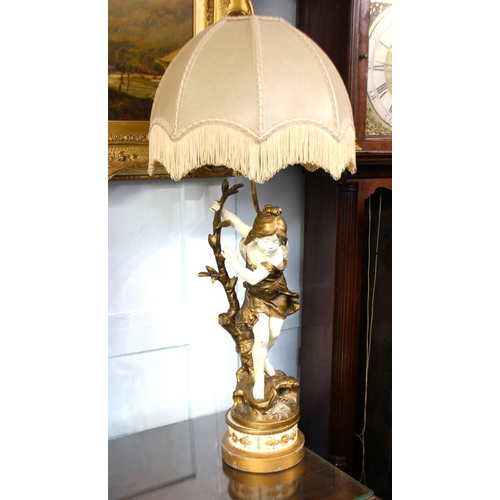 788 - After Moreau, a painted figural table lamp of a youth holding on to a tree branch, on circular base ... 