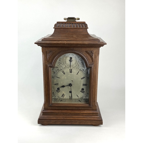 789 - A late 19th/early 20th century German oak bracket clock with arched silvered dial and Roman numerals... 