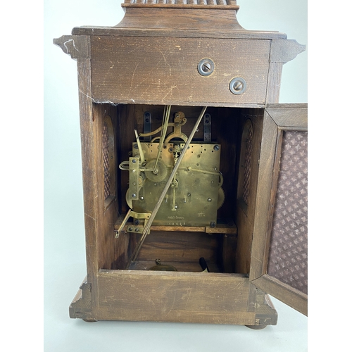 789 - A late 19th/early 20th century German oak bracket clock with arched silvered dial and Roman numerals... 