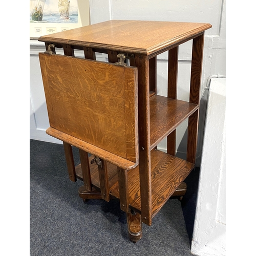 955 - An oak revolving bookstand with adjustable fold down writing slope, on swivel base and castors, 48cm