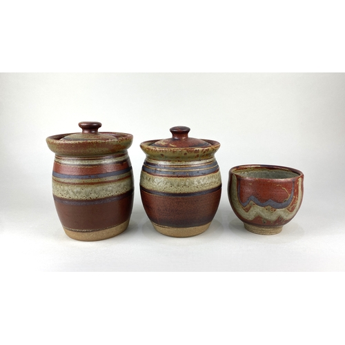 106 - Don Glanville (1937-2004), a near pair of studio pottery jars and covers with striped decoration tog... 