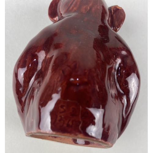 110 - A William Baron Barnstaple art pottery model of a monkey in red gaze 6.5cm high, a CH Brannam art po... 