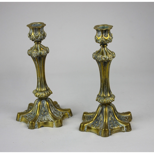 163 - A pair of 19th century cast gilt brass candlesticks, of heavy quality, with stylised foliate and flu... 