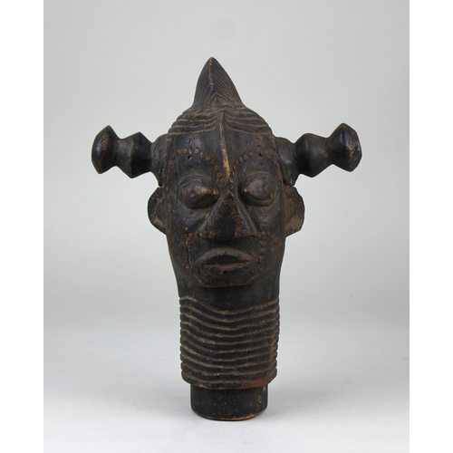 171 - An African tribal carved wooden head, featuring twin handles and inset with metal nails, the wear an... 