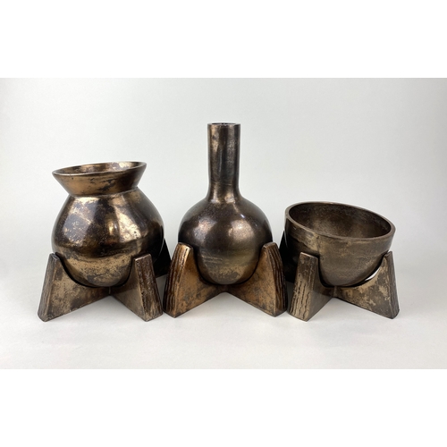 176 - A trio of decorative alchemists style bronzed pots / ornaments, each piece sat on a separate quatref... 