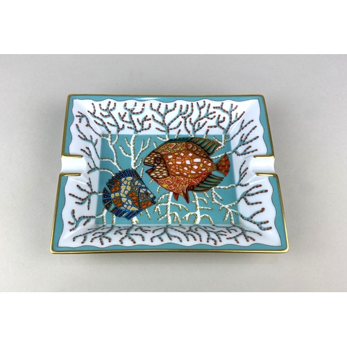 18 - A Hermes Paris porcelain ashtray decorated with exotic fish, with gilt embellishments, 16cm by 20cm,... 