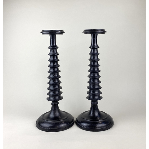 180 - A pair of decorative 'ring turned' style candlesticks, ebonised metal, contemporary, 42cm high.... 