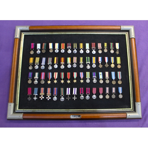 189 - 'British Campaign & Gallantry Medals', replicas, displayed in a military campaign style frame, p... 