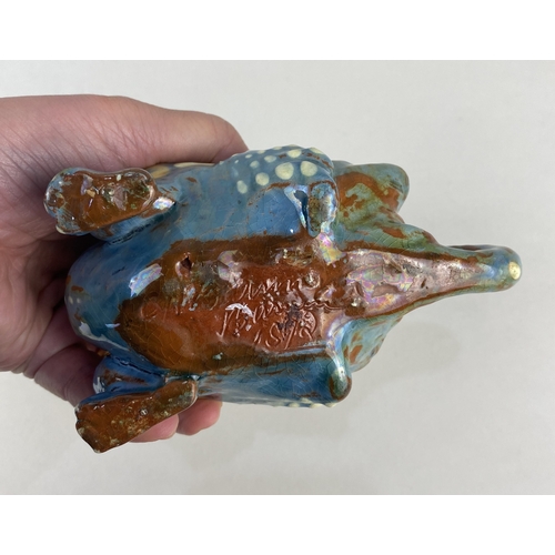 28 - A Brannam Barum art pottery dragon spill / candle holder dated 1892, glazed in blue, brown and yello... 