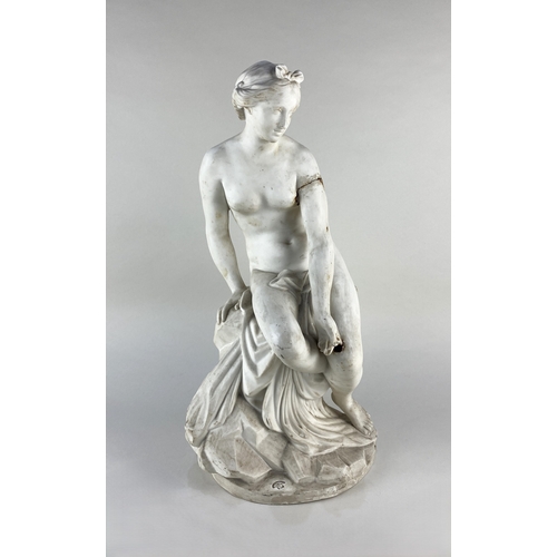 34 - A 19th century Parian ware figure, depicting a naked classical maiden seated on drapes and rocks, in... 