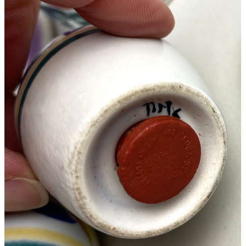 102 - A collection of Poole pottery with floral pattern on white ground, comprising cylinder vase 22cm hig... 