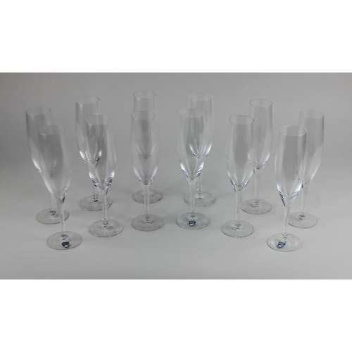 103 - A set of twelve Orrefors glass champagne flutes, some with labels still attached, 21.5cm high with H... 