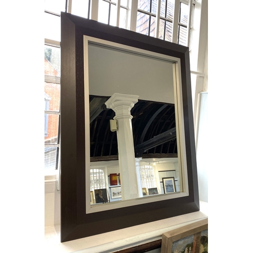 546 - A contemporary wall mirror, the ebonised wooden frame with silvered metal insert, 119cm by 95cm.... 