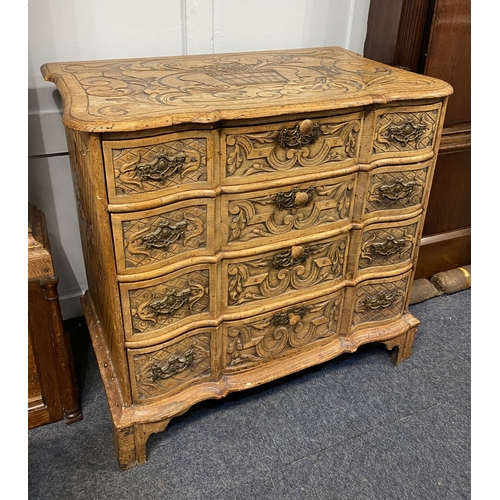 547 - A Continental carved oak chest of four drawers, the top carved with a cornucopia of scrolls and flow... 