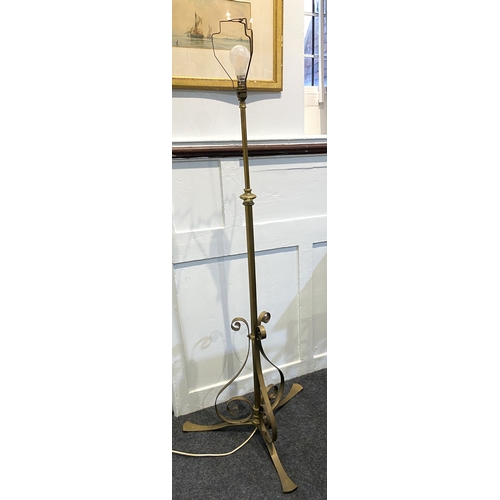 549 - An adjustable brass column standard lamp with three scroll supports and splayed feet... 