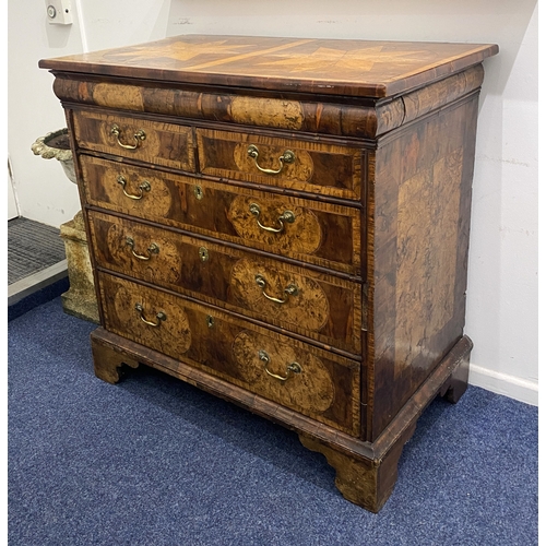 563 - A William and Mary figured and oyster veneered chest of three long and two short crossbanded drawers... 