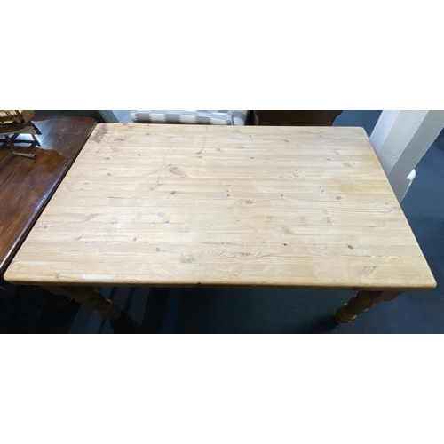 564 - A solid pine kitchen table, 20th century, the rectangular top with rounded corners, raised on turned... 