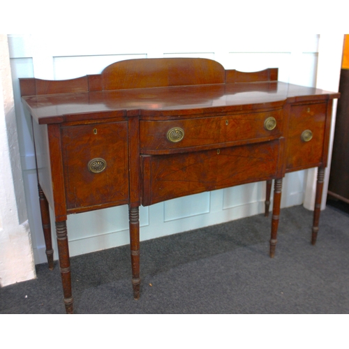 569 - A George III mahogany sideboard decorated with ebony inlay, having a low raised back above a shaped ... 