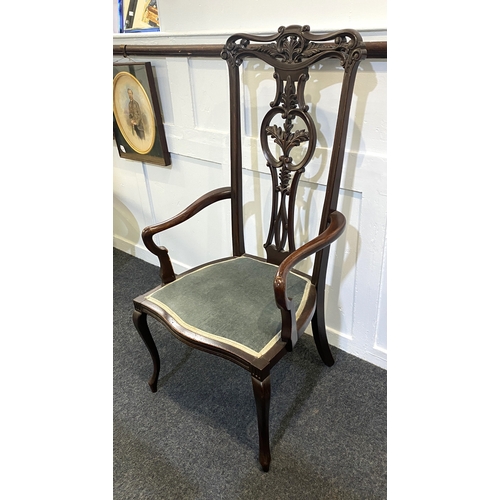 571 - An Edwardian carved mahogany elbow chair, the elegant carved and pierced high back above upholstered... 