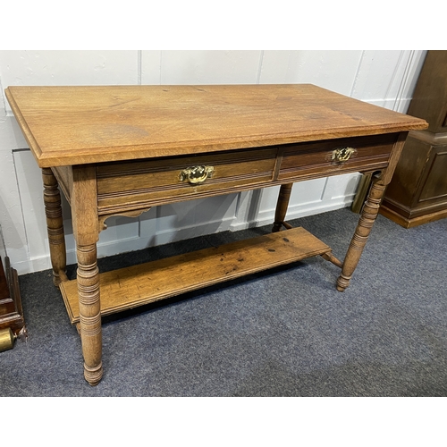 572 - An Edwardian light oak side table, the rectangular top with moulded edges above two frieze drawers a... 