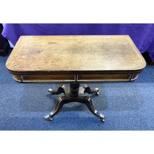 579 - A Regency brass inlaid rosewood card table fold over top with green baize interior and decorative br... 