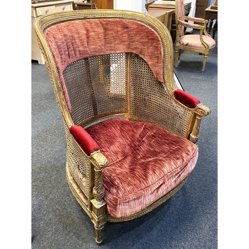 582 - A gilt framed high back cane armchair with red cushioned seat (a/f requires restoration)... 