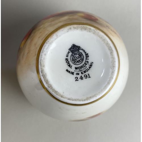 95 - A small Royal Worcester porcelain vase decorated with autumn fruits, signed Freemay, 7.5cm high, and... 