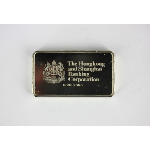 105 - A sterling silver ingot detailed the Hong Kong and Shanghai banking corporation weight 65g with a ca... 