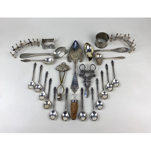 15 - A collection of Dutch silver and silver plated spoons and servers to include a pair of grape scissor... 