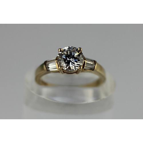 301 - A gold and cubic zirconia ring claw set with the principle circular cut cz at the centre between the... 