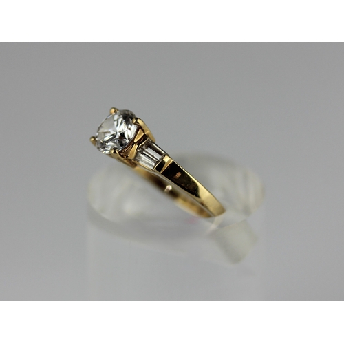 301 - A gold and cubic zirconia ring claw set with the principle circular cut cz at the centre between the... 