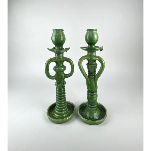 432 - Two similar Art Pottery green glazed candlesticks, possibly French Biot Pottery, early 20th century,... 