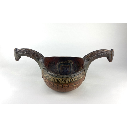 613 - A Scandinavian wooden kasa of traditional form with horse head handles, painted decoration, and insc... 