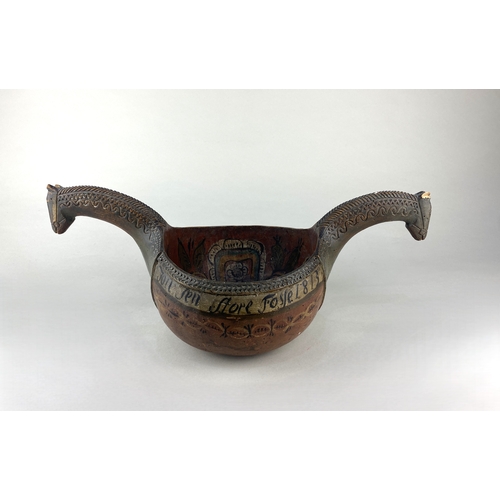613 - A Scandinavian wooden kasa of traditional form with horse head handles, painted decoration, and insc... 