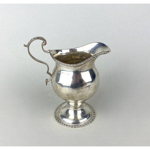 65 - A George V silver cream jug, maker Alfred Marston, Chester 1921, of baluster form with gadrooned bor... 