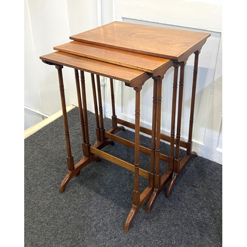 823 - A nest of three George III style crossbanded mahogany side tables with rectangular tops on turned su... 