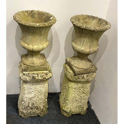 826 - A pair of reconstituted stone garden urns of classical form on plinth bases, combined heights 64cm, ... 