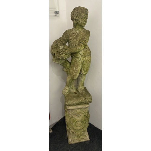 829 - A reconstituted stone garden statue on associated plinth base, modelled as a classical boy carrying ... 