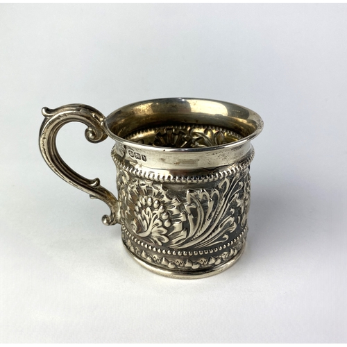 89 - A late Victorian silver mug by Walker & Hall, with embossed foliate decoration and scrolled hand... 