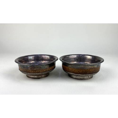 96 - Two Asian white metal mounted burr wood mazer bowls, each of typical flared tapered circular form, a... 