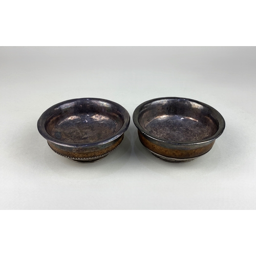 96 - Two Asian white metal mounted burr wood mazer bowls, each of typical flared tapered circular form, a... 