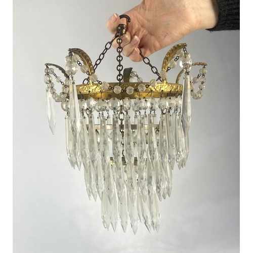 136 - A gilt metal and cut glass three tier circular light fitting with prismatic drops and associated cei... 