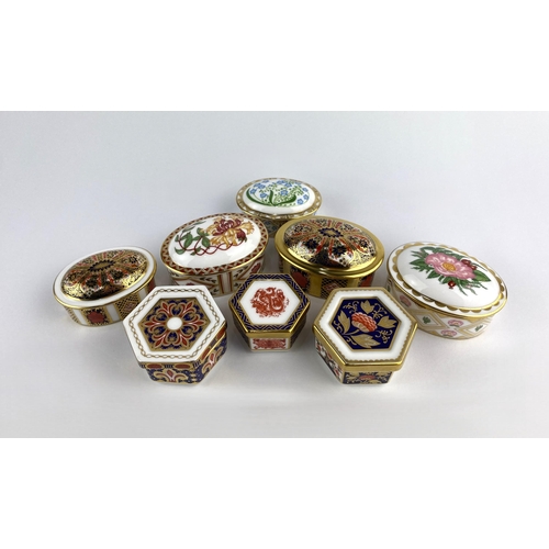 88 - A collection of eight Royal Crown Derby porcelain boxes and covers, patterns including 'Honeysuckle'... 