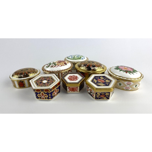 88 - A collection of eight Royal Crown Derby porcelain boxes and covers, patterns including 'Honeysuckle'... 