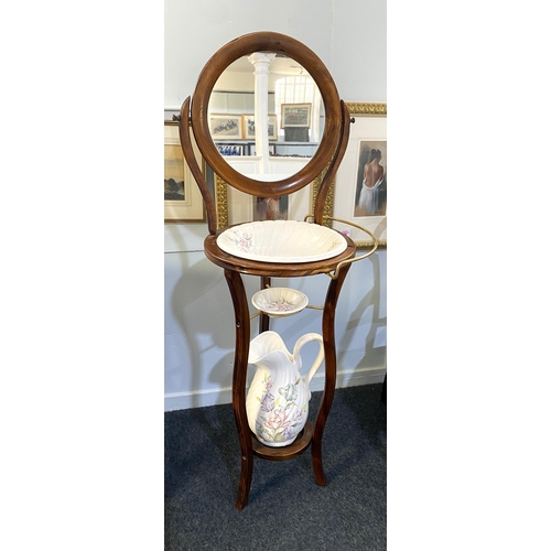 868 - A beech wash stand in the 19th century French taste, having an adjustable circular mirror above a fi... 