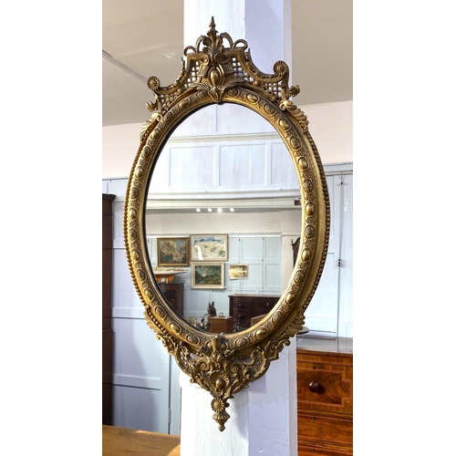 872 - A good decorative 19th century gilt gesso oval wall mirror, with relief moulded and pierced decorati... 
