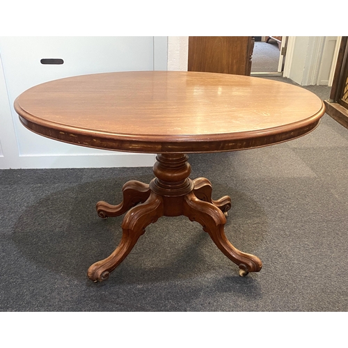 881 - A Victorian mahogany oval loo table, the hinged top with moulded edges raised on a solid baluster tu... 